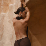 Back shot of model wearing a brown halter maxi dress. 