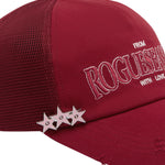 Close up detail shot of red cap with 'ROGUESEASON' branding and star design on a white background