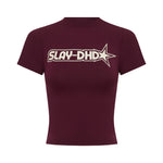 A short-sleeve top in burgundy with a cream 'SLAY-DHD' star graphic printed across the chest, displayed on a solid white background.